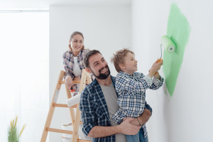 Happy,Young,Family,Renovating,Their,Home,,The,Father,Is,Holding